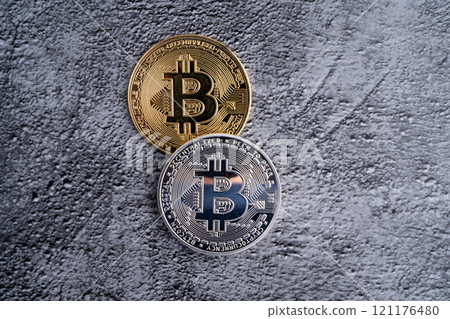 Silver and gold bitcoin coins close-up on concrete gray background Silver and gold bitcoin coins close-up on concrete gray background 121176480