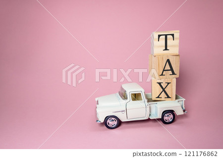 White truck is carrying a stack of wooden blocks on top of it 121176862