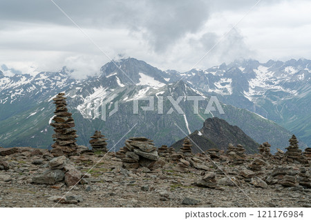Mountain Landscape With Stacked Stone Cairns in Cloudy Weather Mountain Landscape With Stacked Stone Cairns in Cloudy Weather 121176984