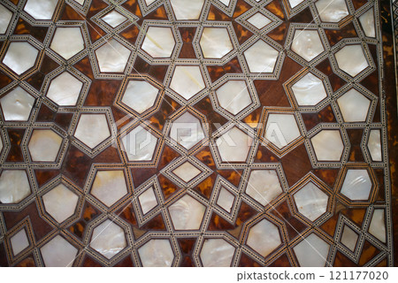 Islamic geometric pattern in wood and nacre. Background 121177020