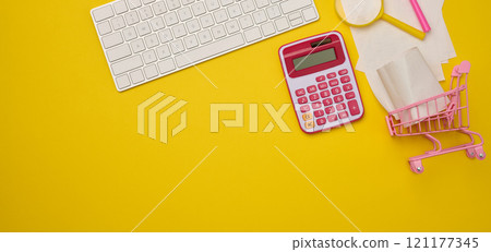White wireless keyboard, stack of paper receipts and magnifier on yellow background, budget analysis concept, savings White wireless keyboard, stack of paper receipts and magnifier on yellow background, budget analysis concept, savings 121177345