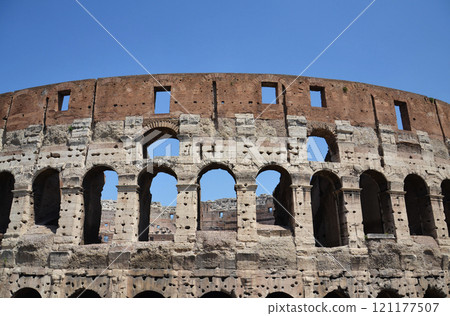 Walls of the Roman Colosseum in Rome, Italy, sunny day, clear blue sky 121177507