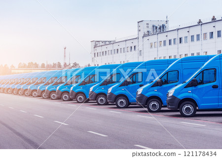 Freight trucks stand by the storage building at evening time. Freight trucks stand by the storage building at evening time. 121178434