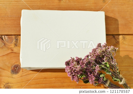A small bouquet of dried Japanese eupatorium flowers and a canvas 121178587