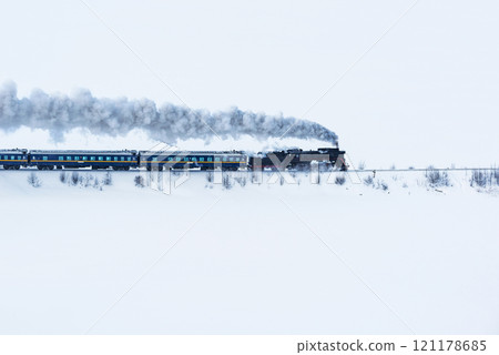 Retro steam train moves at winter morning. 121178685