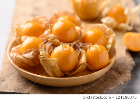 Cape gooseberry or Golden berry (Physalis peruviana) in wooden bowl, Healthy fruit 121180376