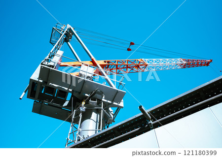 Building construction site, blue sky and tower crane starting to extend, a-4 light color Building construction site, blue sky and tower crane starting to extend, a-4 light color 121180399