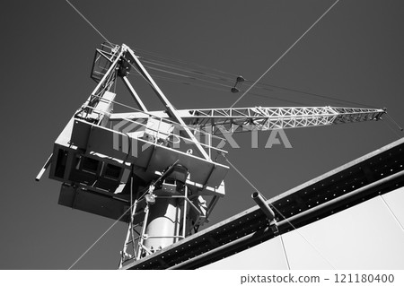 Building construction site, blue sky and tower crane starting to extend, a-5 monochrome Building construction site, blue sky and tower crane starting to extend, a-5 monochrome 121180400