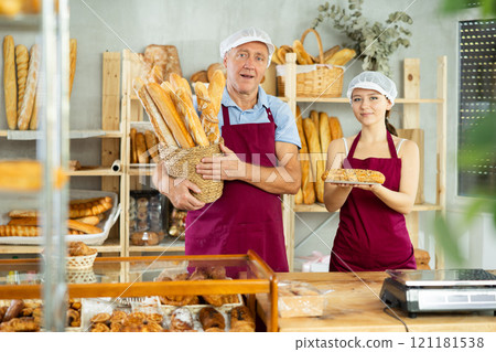 Elderly man and young woman sellers with baguettes and bocadillo Elderly man and young woman sellers with baguettes and bocadillo 121181538