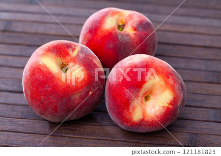 Delicious ripe peaches fruit on wooden surface in kitchen Delicious ripe peaches fruit on wooden surface in kitchen 121181823