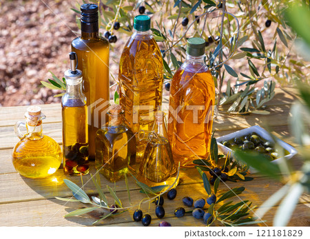 Glass bottles and carafes with olive oil Glass bottles and carafes with olive oil 121181829