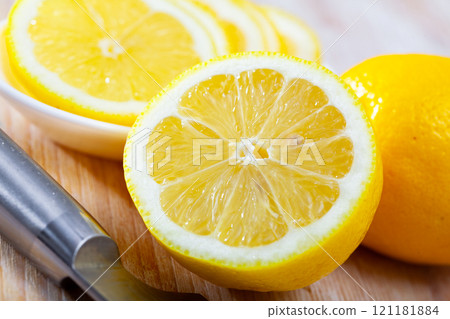 Lemon and knife on cutting board 121181884