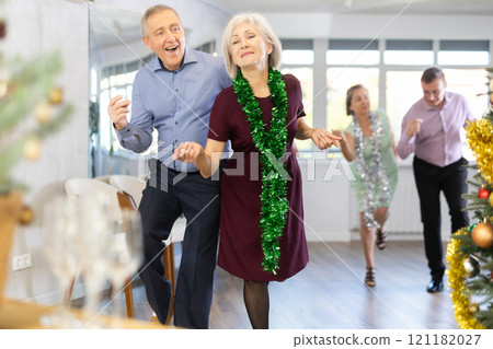 In studio decorated for New Year, elderly man and woman perky dance pair discofox. In studio decorated for New Year, elderly man and woman perky dance pair discofox. 121182027