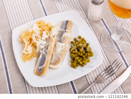 Salted herring fillet with pickled cabbage and green peas Salted herring fillet with pickled cabbage and green peas 121182246