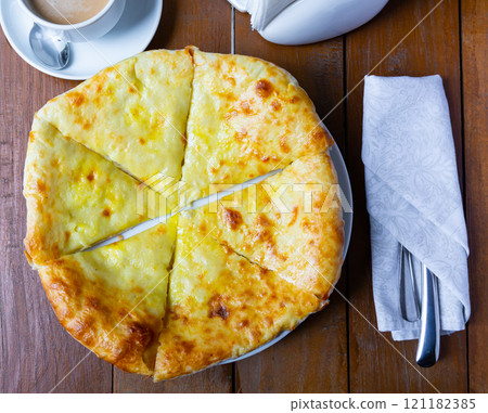 Freshly baked Imeretian khachapuri topped with sulguni cheese 121182385