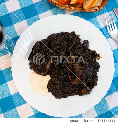 Traditional Valencian seafood black paella Arroz negro with squid ink Traditional Valencian seafood black paella Arroz negro with squid ink 121182454