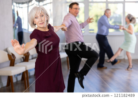 Adult man and elderly woman dance twist 121182489