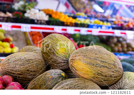 Sweet melons on the counter of the fruit store Sweet melons on the counter of the fruit store 121182611