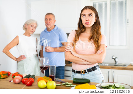 Offended young woman standing back to her parents Offended young woman standing back to her parents 121182636