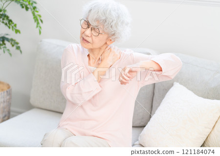 Senior woman suffering from stiff shoulders 121184074