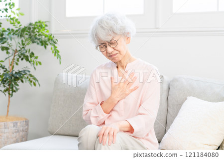 Senior woman with esophagitis 121184080