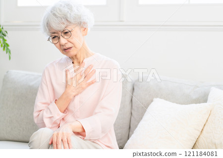 Senior woman with esophagitis 121184081