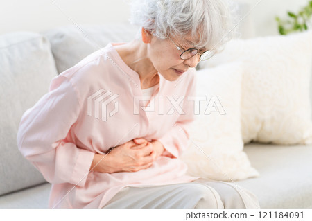 Senior woman holding her stomach 121184091