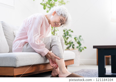 Senior woman with calf cramps 121184104