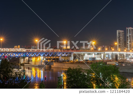 The scyscrapers of the Moscow City at night and the Dorogomilovsky bridge with illumination. Translation of text - street names: Krasnopresnenskaya, center, etc. The scyscrapers of the Moscow City at night and the Dorogomilovsky bridge with illumination. Translation of text - street names: Krasnopresnenskaya, center, etc. 121184420