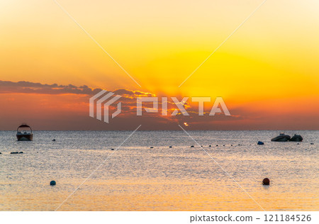 Beautiful yellow and orange sunrise over the sea. 121184526