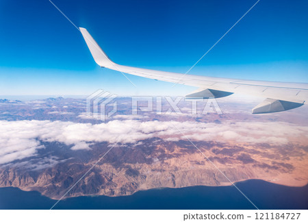 View from the airplane window of the mountains and sea resort with corals in Egypt, Sharm El Sheikh.Flight 121184727