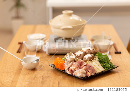 Ingredients for hot pot and clay pot on a winter evening dinner table Ingredients for hot pot and clay pot on a winter evening dinner table 121185055