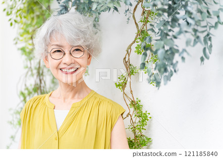 Senior woman wearing a yellow dress Senior woman wearing a yellow dress 121185840