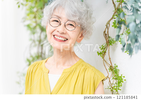 Senior woman wearing a yellow dress Senior woman wearing a yellow dress 121185841
