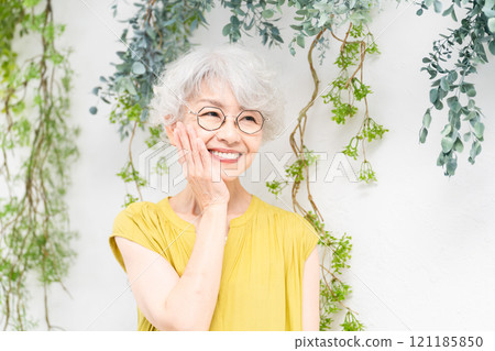 Senior woman wearing a yellow dress Senior woman wearing a yellow dress 121185850