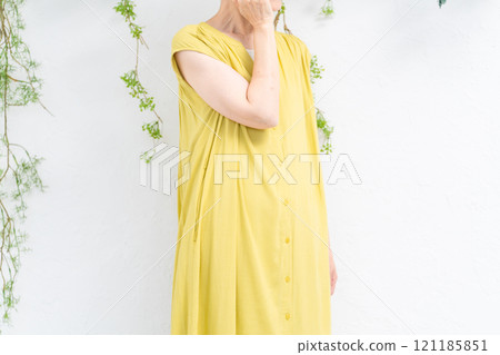 Senior woman wearing a yellow dress Senior woman wearing a yellow dress 121185851