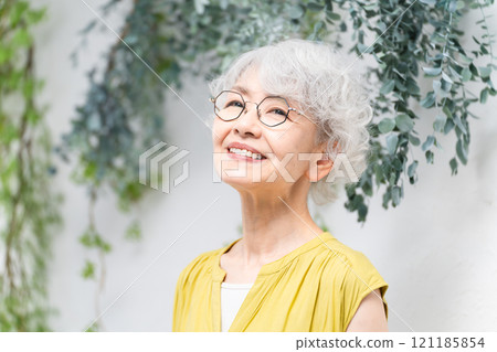 Senior woman wearing a yellow dress Senior woman wearing a yellow dress 121185854