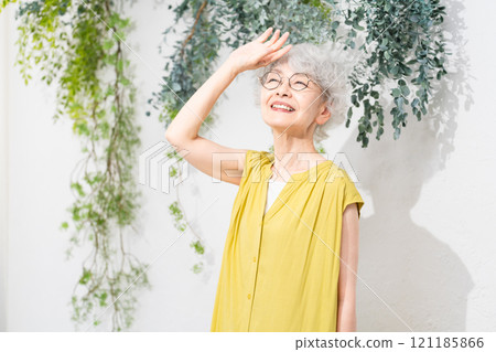 Senior woman wearing a yellow dress Senior woman wearing a yellow dress 121185866