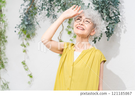 Senior woman wearing a yellow dress Senior woman wearing a yellow dress 121185867