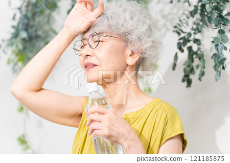Senior woman taking measures against heat stroke Senior woman taking measures against heat stroke 121185875
