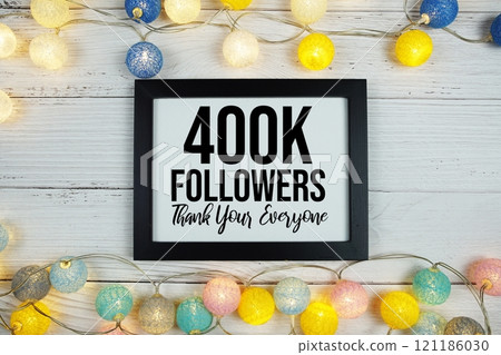 Thanks You 400000, 400K Followers text written on blackboard with LED cotton balls decoration on wooden background Thanks You 400000, 400K Followers text written on blackboard with LED cotton balls decoration on wooden background 121186030