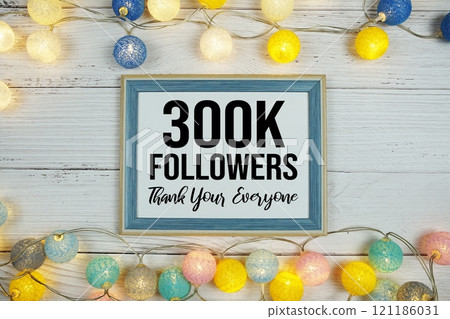 Thanks You 300000, 300K Followers text written on blackboard with LED cotton balls decoration on wooden background 121186031