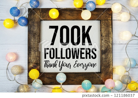 Thanks You 700000, 700K Followers text written on blackboard with LED cotton balls decoration on wooden background Thanks You 700000, 700K Followers text written on blackboard with LED cotton balls decoration on wooden background 121186037