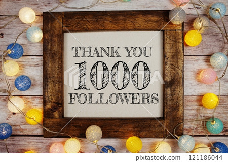 Thanks You 1000000, 1000K Followers text written on blackboard with LED cotton balls decoration on wooden background Thanks You 1000000, 1000K Followers text written on blackboard with LED cotton balls decoration on wooden background 121186044