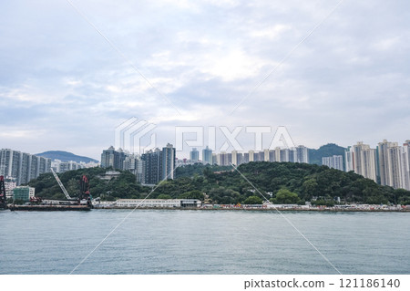 The waterfront of the Kowloon Peninsula lined with high-rise residential buildings The waterfront of the Kowloon Peninsula lined with high-rise residential buildings 121186140