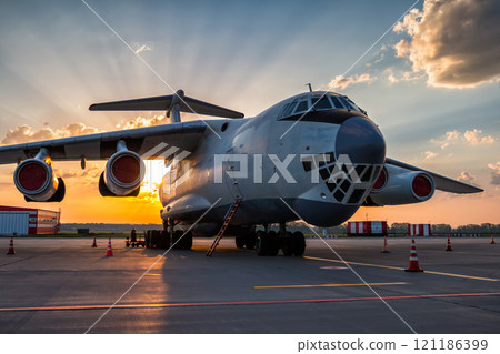 Wide body transport cargo aircraft at airport apron in the morning sun 121186399