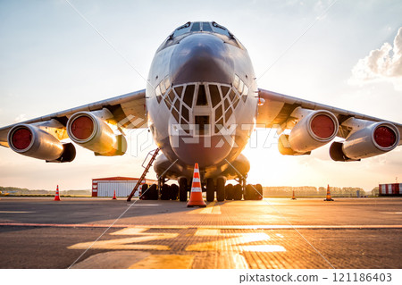 Wide body transport cargo aircraft at airport apron in the morning sun Wide body transport cargo aircraft at airport apron in the morning sun 121186403
