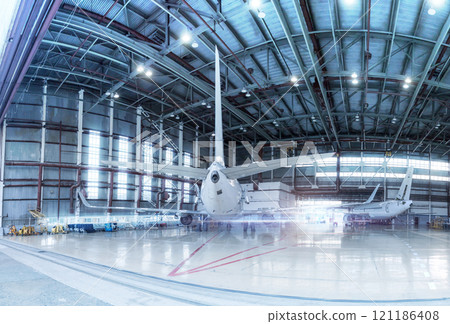 Passenger aircrafts under maintenance. Checking mechanical systems for flight operations. Panorama of airplanes in the hangar 121186408