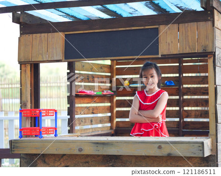 Cute girl playing in the playground during summer vacation. Happy children having fun in an outdoor park. 121186511