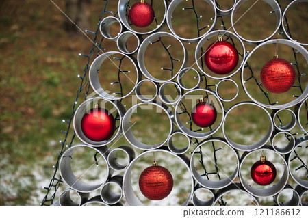 Creative Christmas Decoration With Red Ornaments and Metal Circular Frames Outdoors 121186612